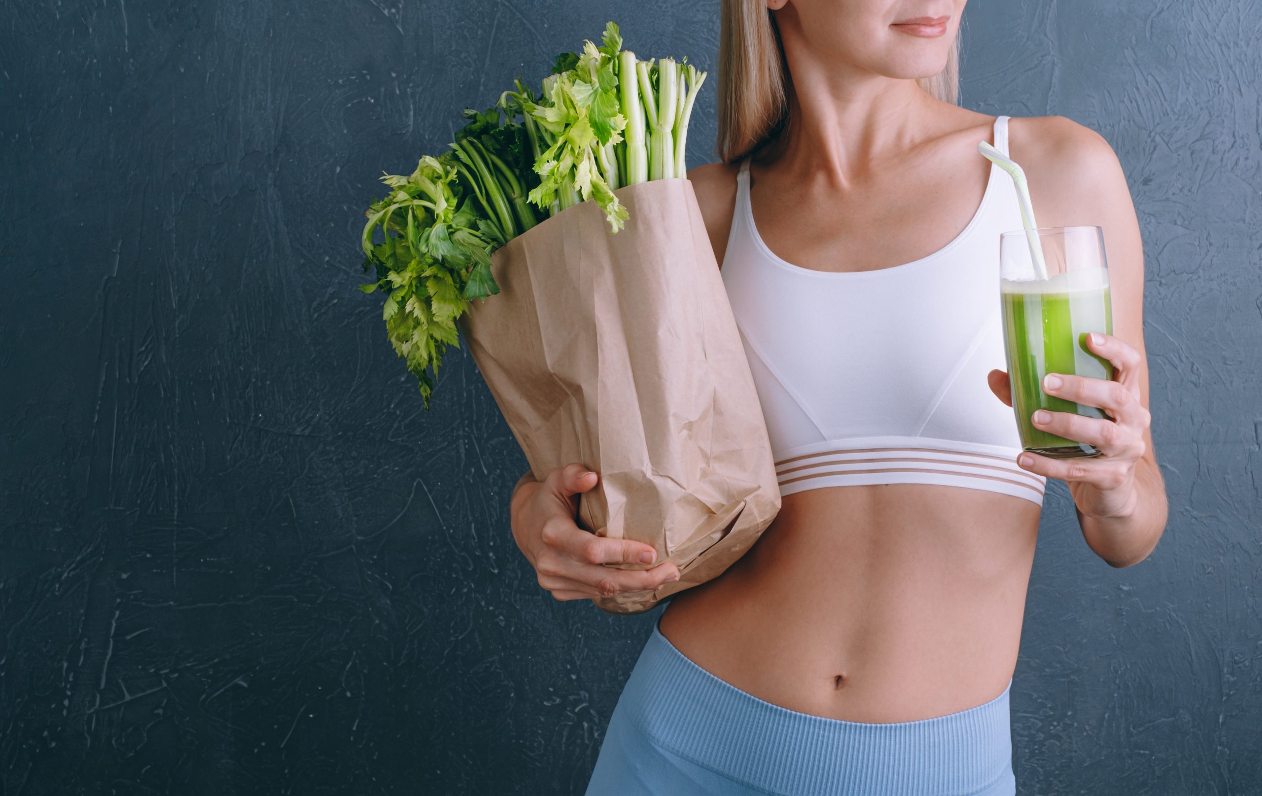 Young Woman Holding A Glass Of Celery Juice And A Bag Of Fresh Celery