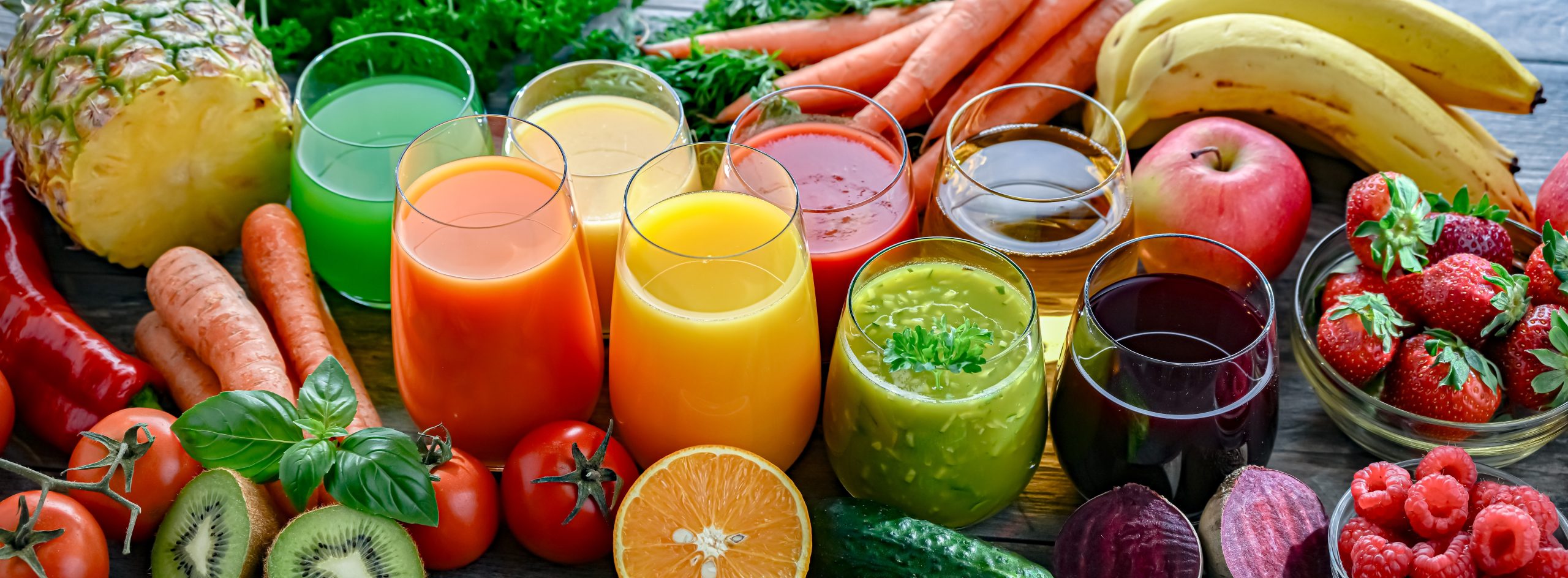 Juicing ingredients display with glasses of fresh juice